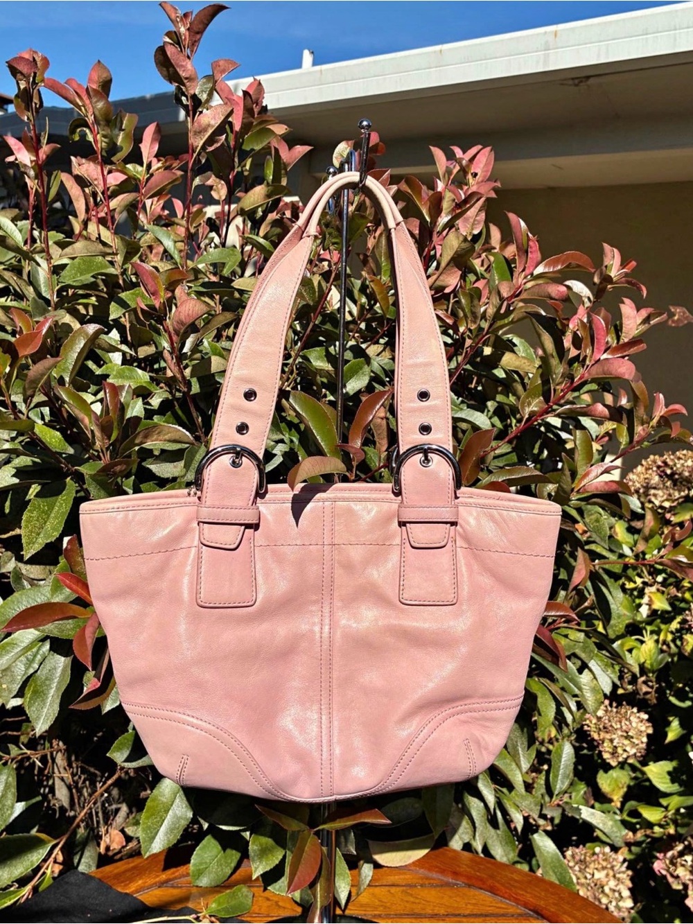 Vintage light pink Coach Soho leather tote bag accented with silver-tone buckle